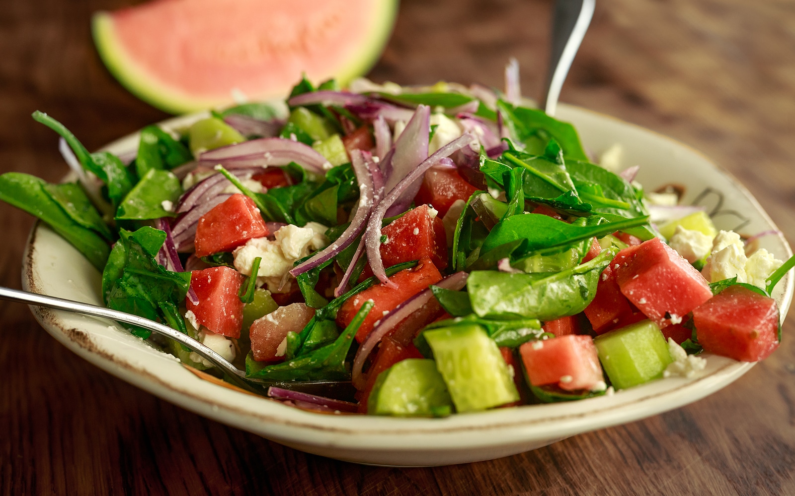 Watermelon Salad with Feta cheese, Cucumber, spinach, red onions and olive oil.