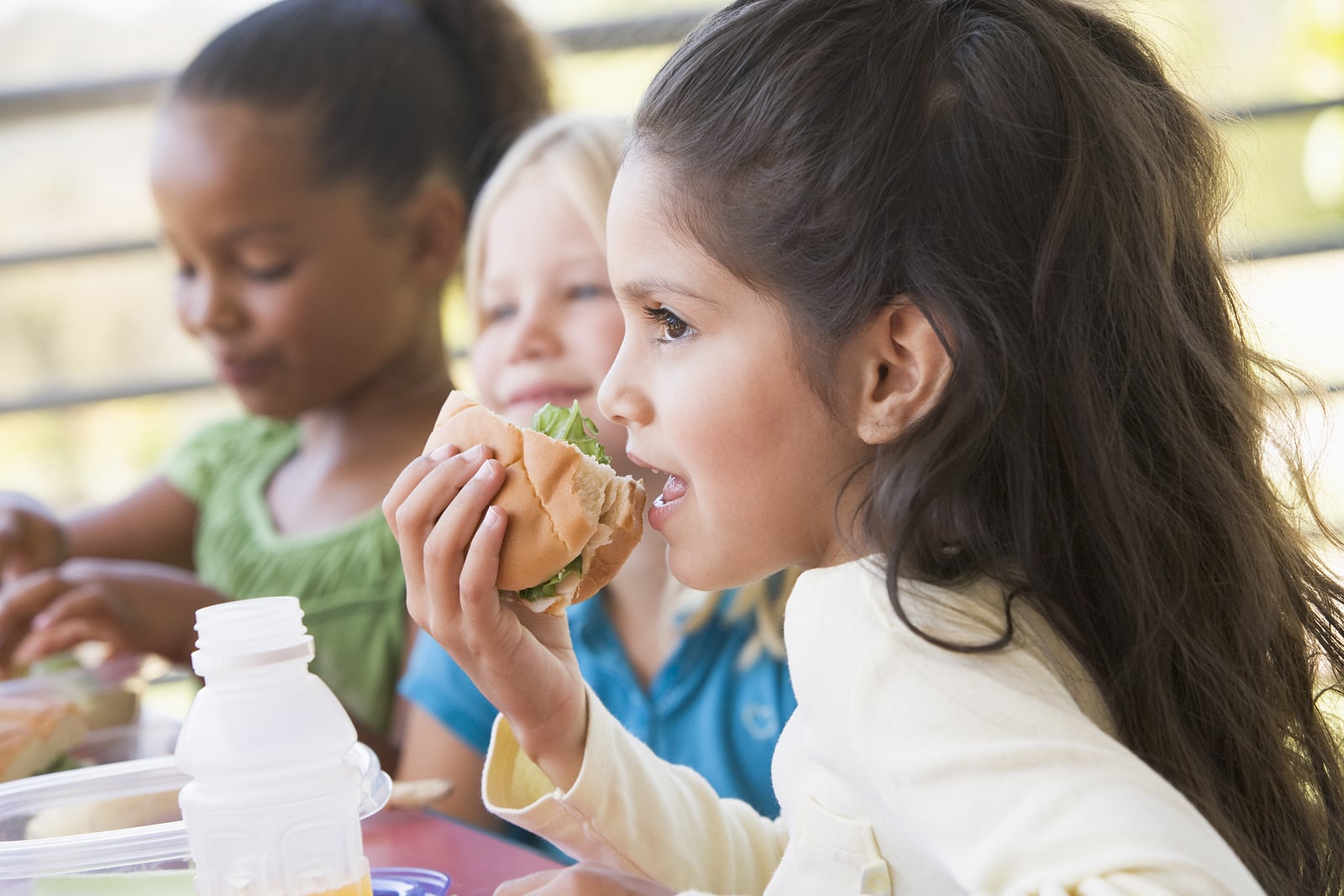 Students outdoors eating lunch.