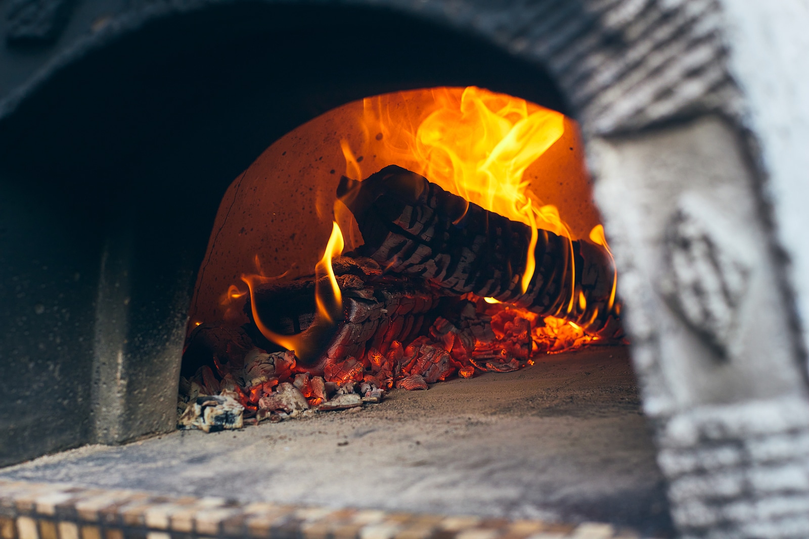 Wood-fired pizza oven with birch logs for kindling. 