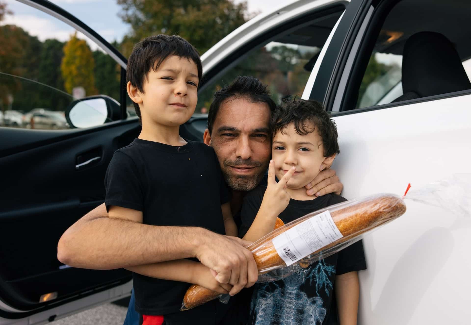 A father and sons with bread at GPCFB.