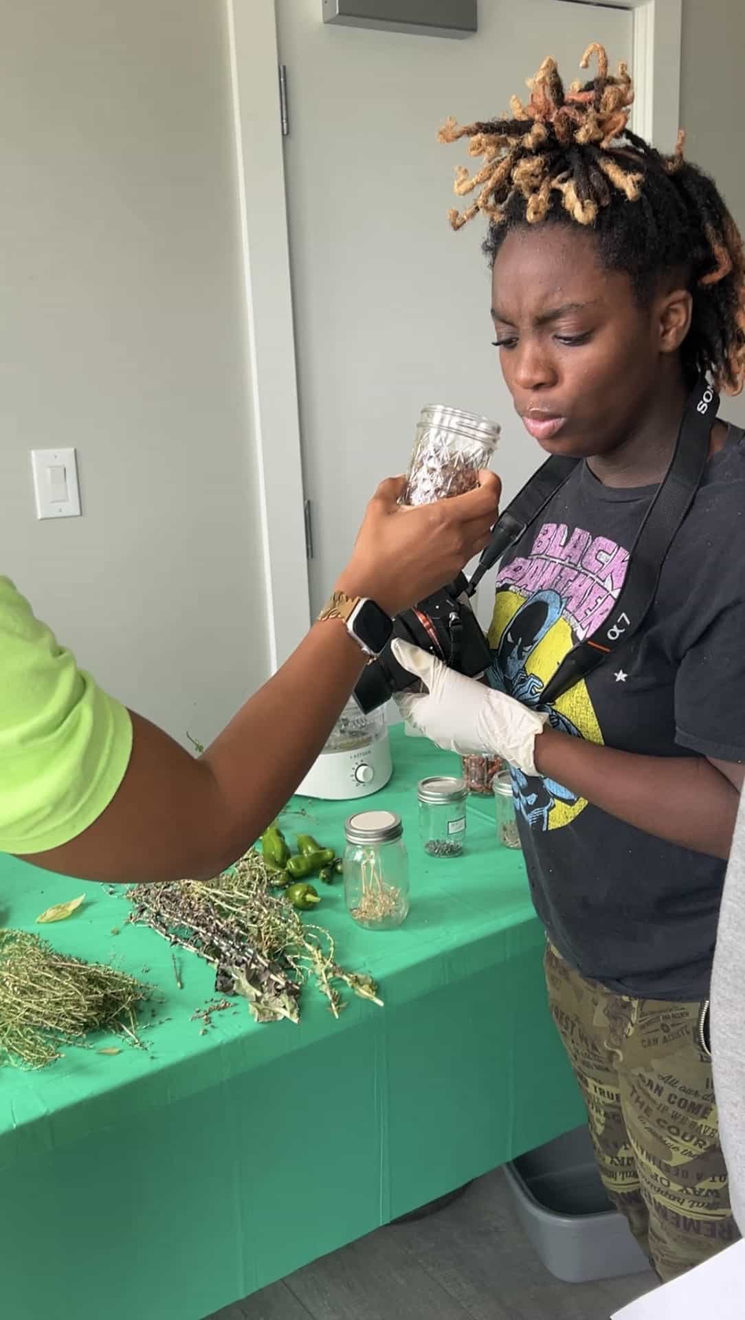 Promise smelling a dried herbal concoction she made