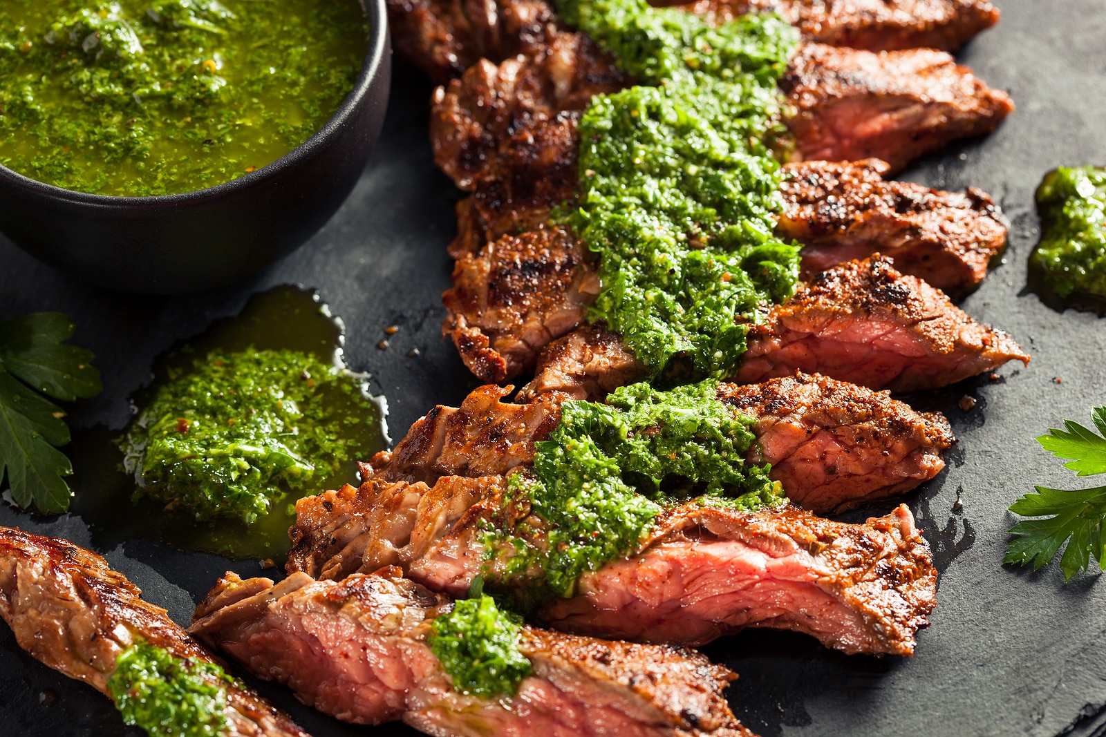 Homemade cooked skirt steak with chimichurri sauce.