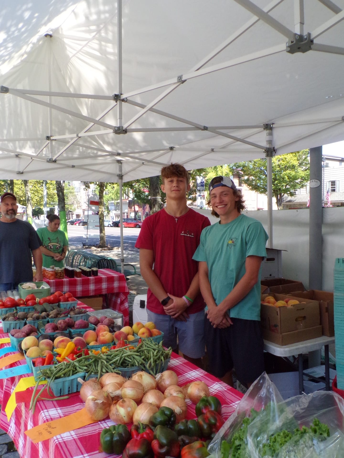 People standing by fresh produce at Pottstown FARM.