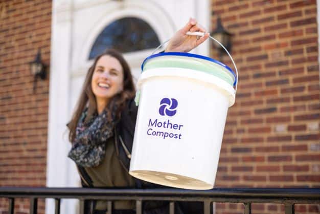 Gwenn Nolan of Mother Compost, holding a collection bucket.