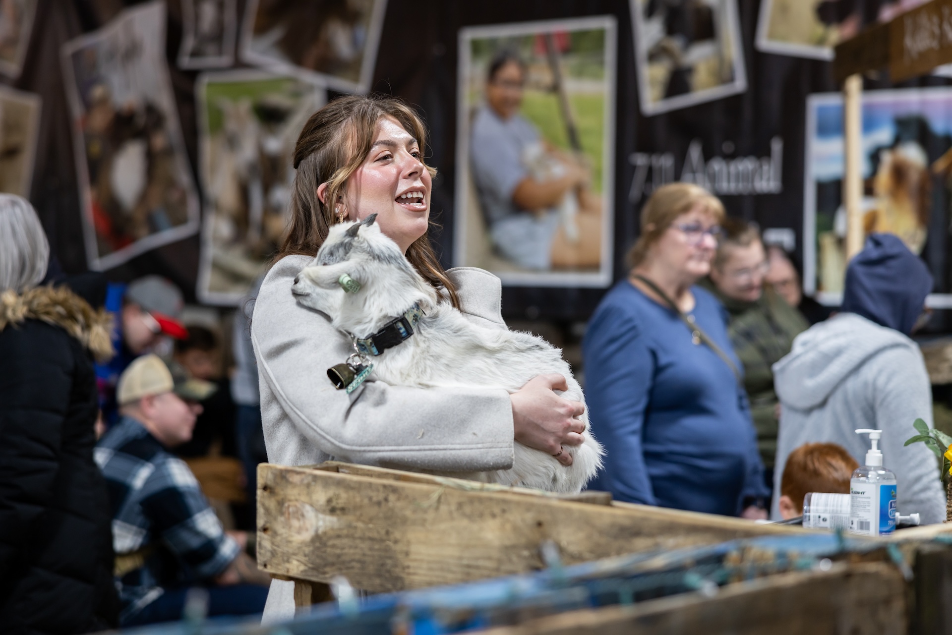 A woman snuggling a goat at PA Farm Show.