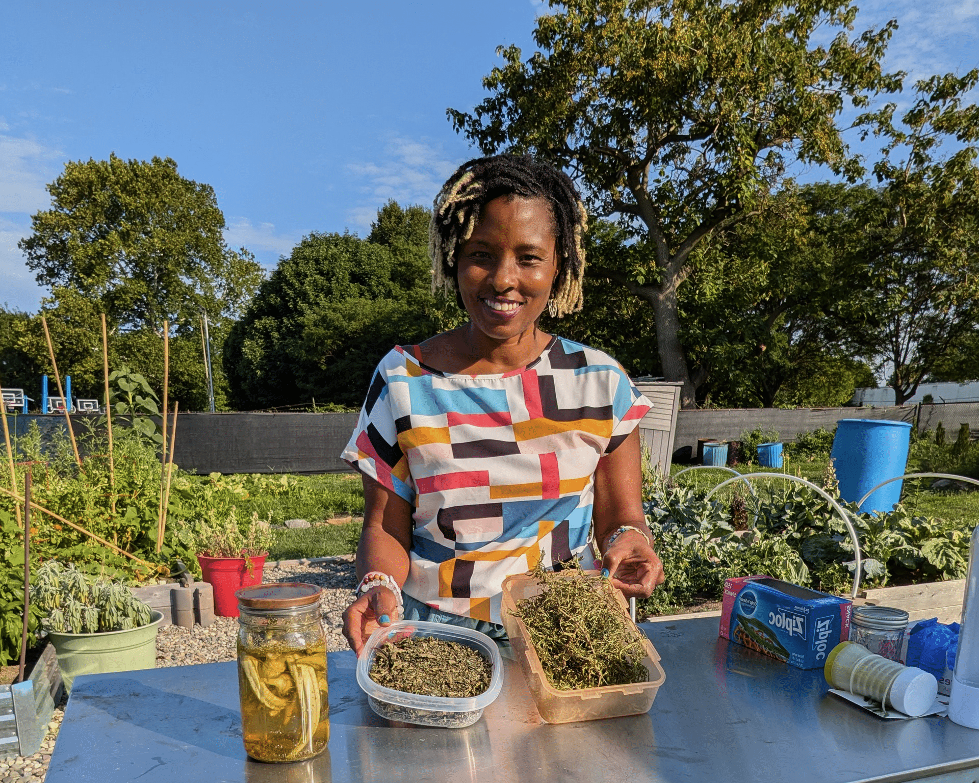 Stacey Woodson with dried herbs in a community garden.