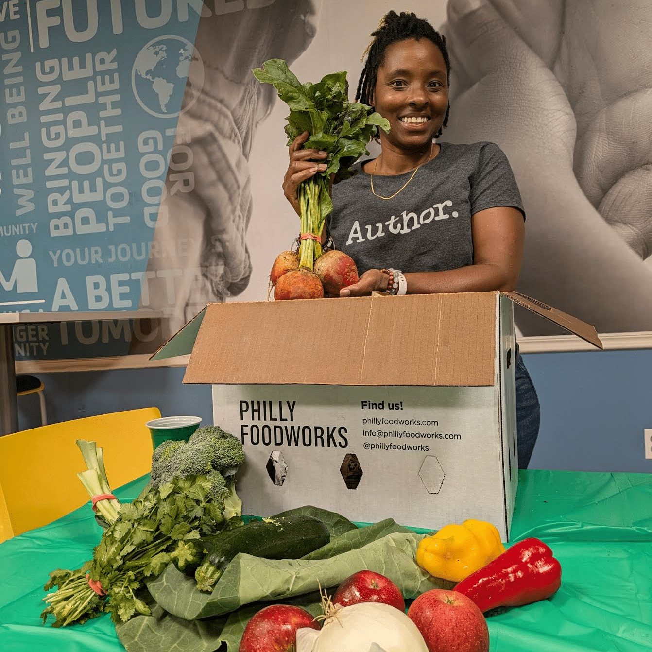 Stacey Woodson with a box of fresh produce.