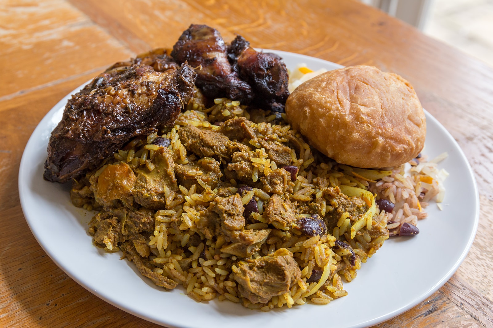 Curried goat, jerk chicken and fried dumpling.