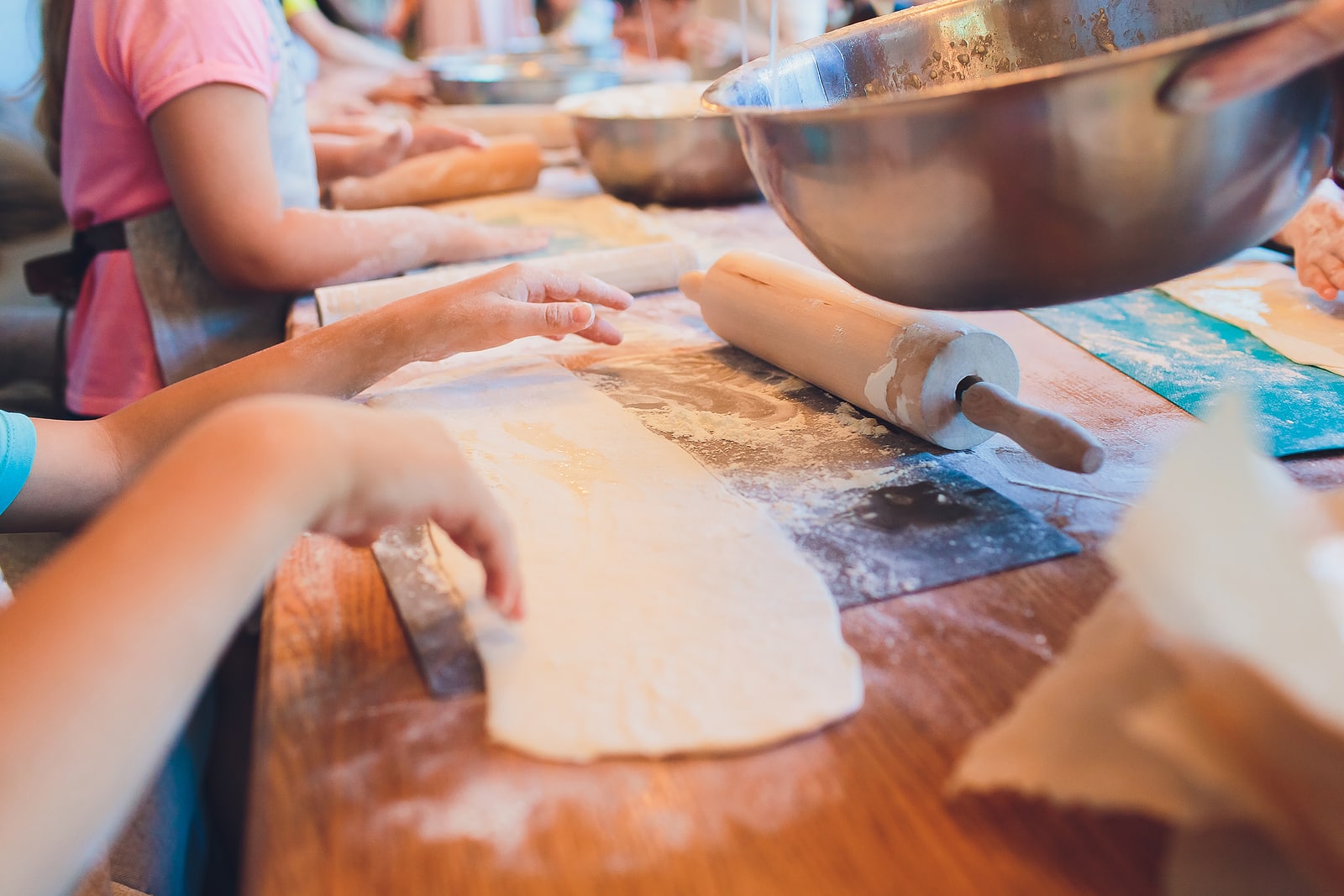 Childrens master class in cooking pizza flour at summer camp.